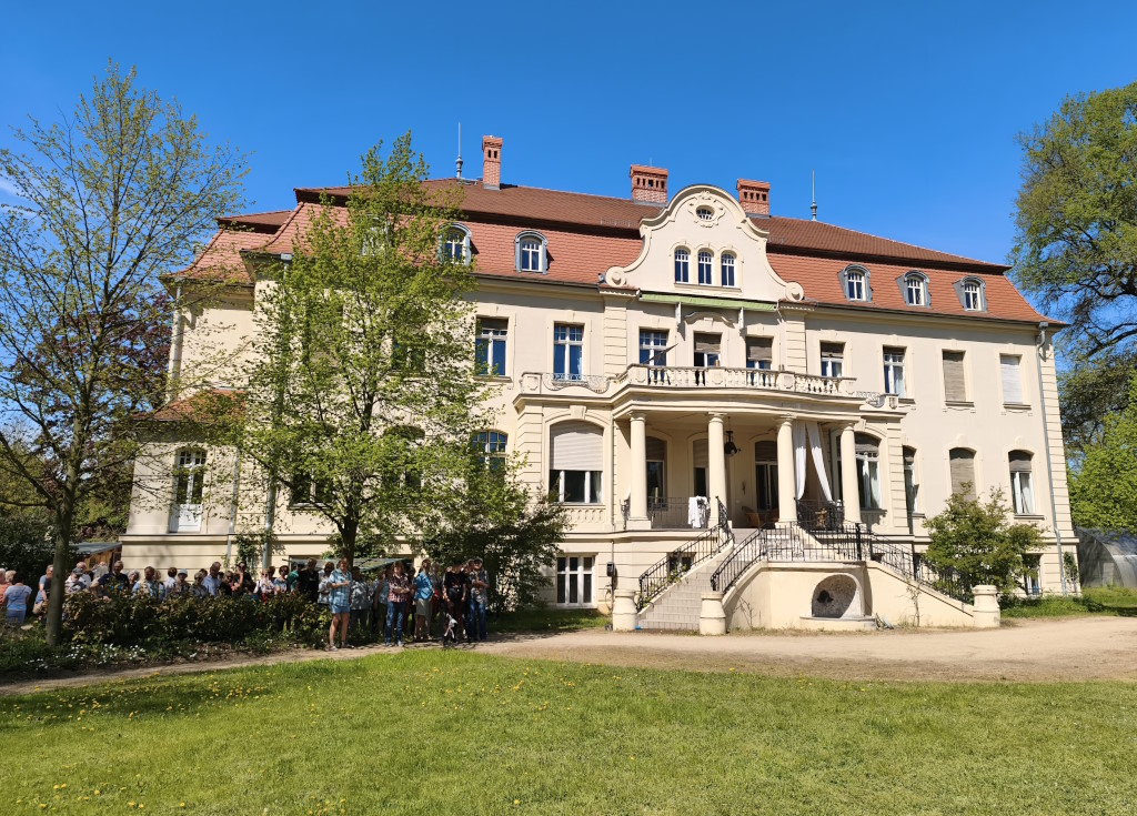 Die erste Besuchergruppe steht an der Treppe zum Gutshaus Kaltenhausen.
